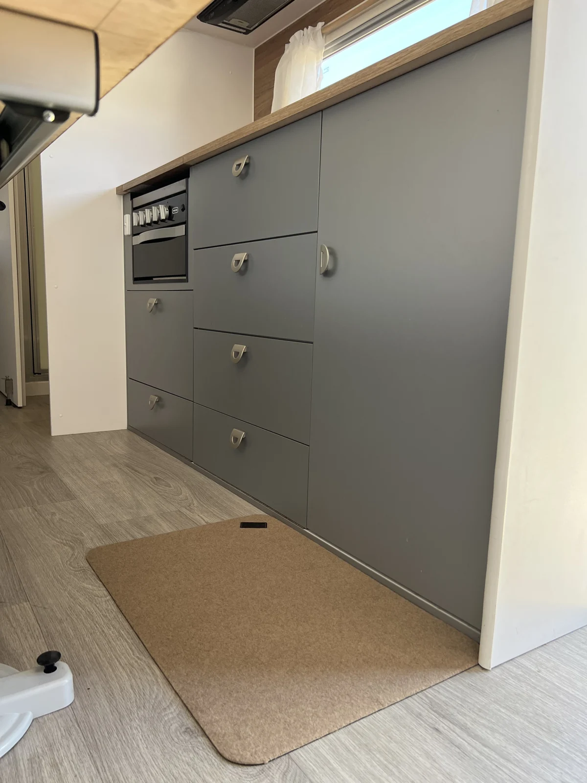 Pebble Conni floor mat beside the galley cupboards in a caravan